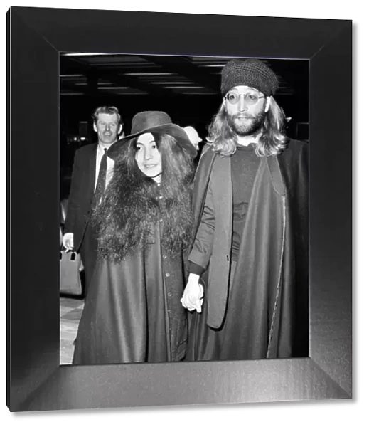John Lennon and Yoko Ono dressed all in black, pictured at Heathrow today as they leave