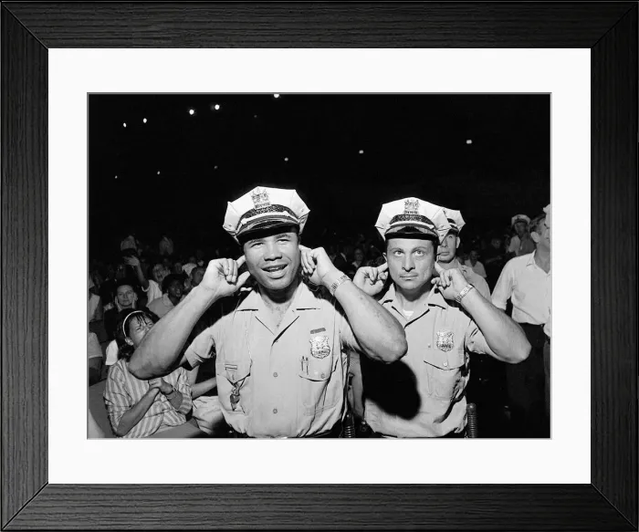 Framed Print : Two policemen try to block out the noise of the band playing Framed Print : Two policemen try to block out the noise of the band playing