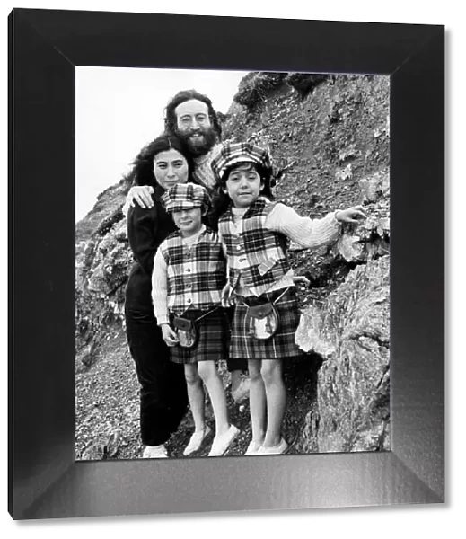 Yoko Ono and John Lennon stand on mountain side with Julian Lennon and Kyoko