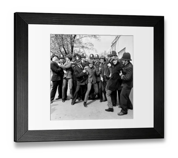 Framed Print : The Beatles in the strong arm of the law while filming Help Framed Print : The Beatles in the strong arm of the law while filming Help