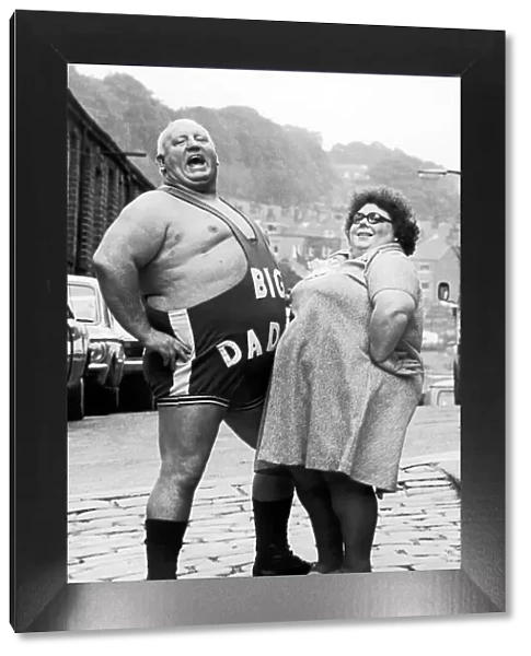 Wrestler Shirley Crabtree alias Big Daddy poses with a fan. 4th September 1980