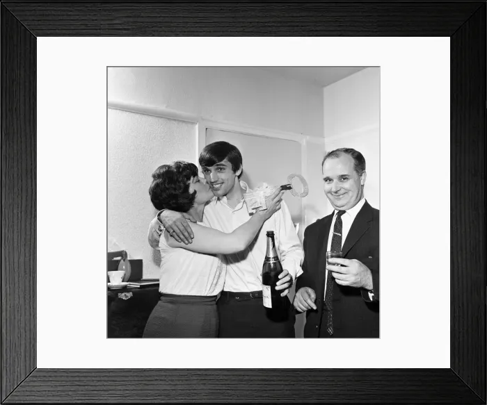 Framed Print : Manchester United footballer George Best with black eye holding champagne bottle as he Framed Print : Manchester United footballer George Best with black eye holding champagne bottle as he