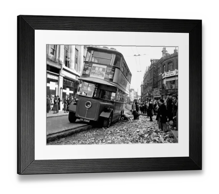 Framed Print : London Bus having puncture repaired on a busy street. 9th March 1933