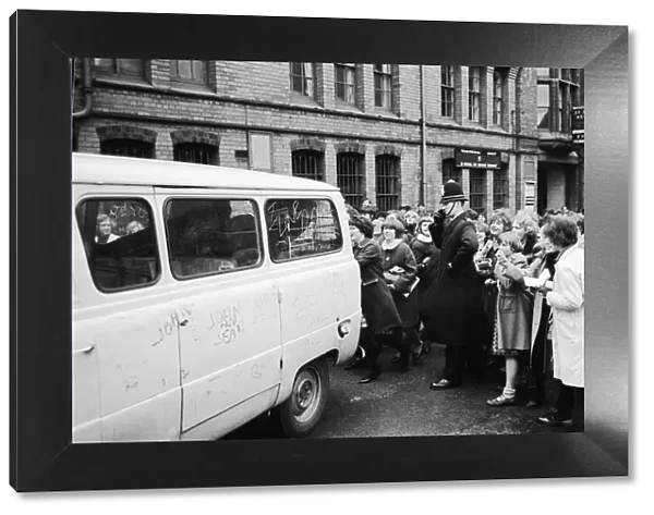 The Beatles leave Birmingham in a van surrounded by hundreds of screaming fans