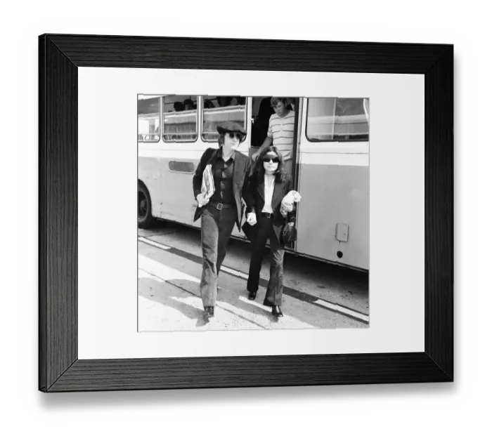 Framed Print : Former Beatles singer and songwriter John Lennon and wife Yoko Ono holding hands as they Framed Print : Former Beatles singer and songwriter John Lennon and wife Yoko Ono holding hands as they