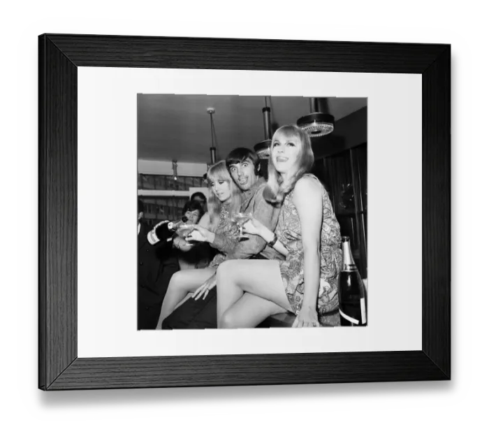 Framed Print : Manchester United footballer George Best celebrates the opening of his fashion boutique