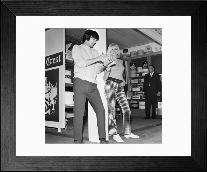 Framed Print : Manchester United footballer George Best at Manchester Exhibition Hall with Sue Hawley Framed Print : Manchester United footballer George Best at Manchester Exhibition Hall with Sue Hawley