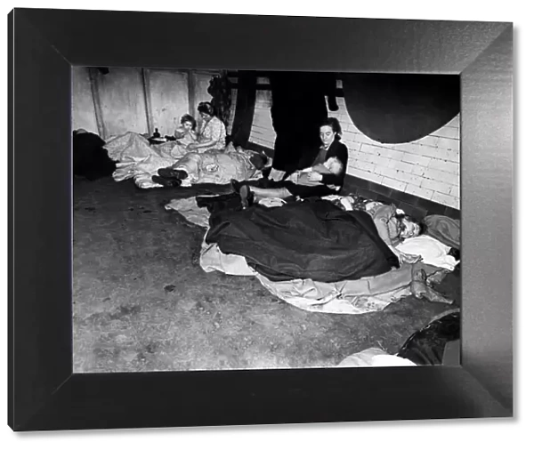Woman feeding her baby in an underground tube station used as an air raid shelter during