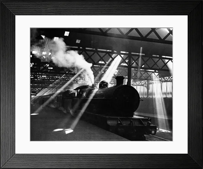 Framed Print : Through the murk and lattice work roof, a pyramid of light shafts surround a London Framed Print : Through the murk and lattice work roof, a pyramid of light shafts surround a London