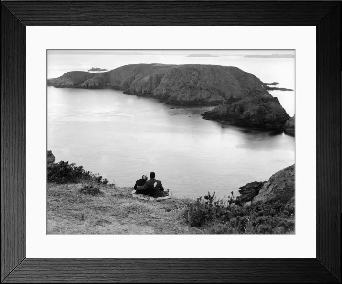 Framed Print : A couple enjoy some time together looking out across the sea on the Channel Island of Framed Print : A couple enjoy some time together looking out across the sea on the Channel Island of