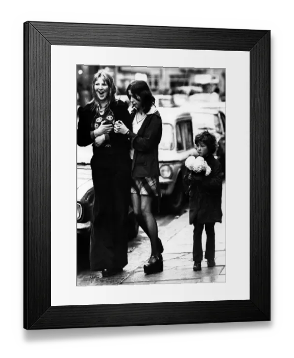 Framed Print : A child selling paper flowers on the streets of Newcastle on 27th December 1974