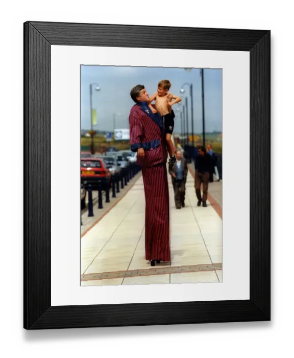 Framed Print : Mike Bridge with Dean Kennedy, 7, on stilts helps relaunch historic Seaham promenade