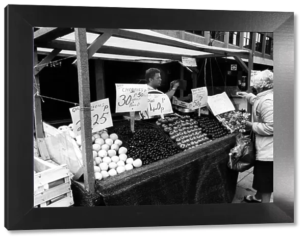 A street trader on the streets of Newcastle selling fruit