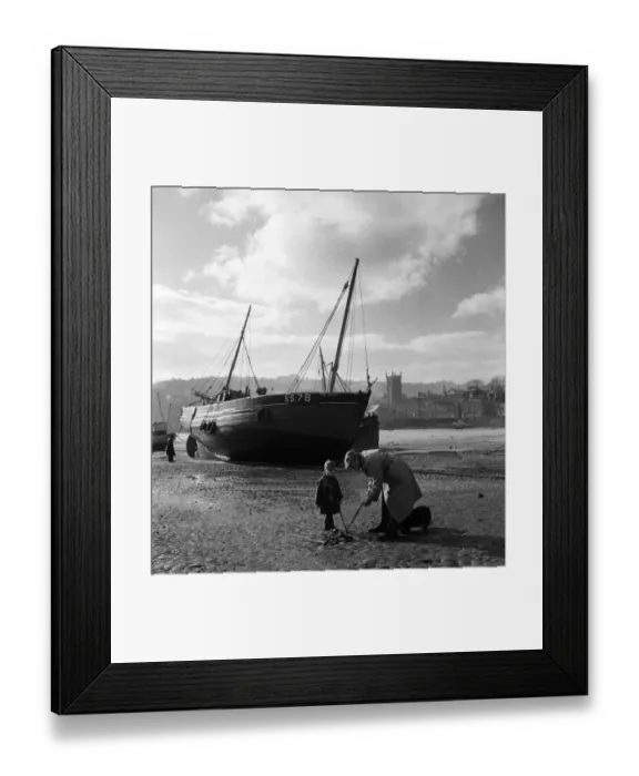 Framed Print : An elderly man at the harbour in the village of St Ives in Cornwall with a young boy Framed Print : An elderly man at the harbour in the village of St Ives in Cornwall with a young boy