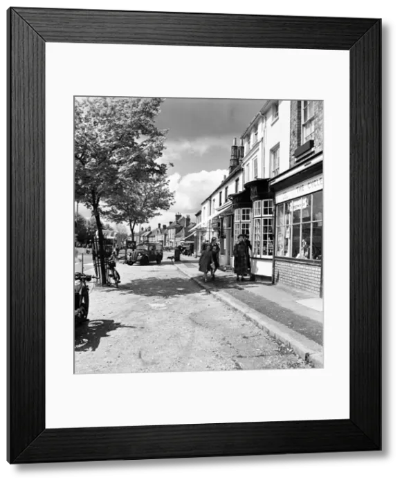 Framed Print : Street scene in Beaconsfield, Buckinghamshire. Women and young girls walking down Framed Print : Street scene in Beaconsfield, Buckinghamshire. Women and young girls walking down