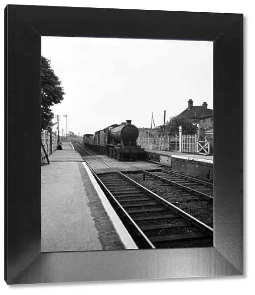 Goods train pulls into the railway station at Halesworth Suffolk. June 1952 C3365