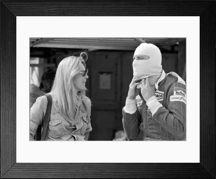 Framed Print : James Hunt talks to a female friend at a practice day for the British Grand Prix held Framed Print : James Hunt talks to a female friend at a practice day for the British Grand Prix held