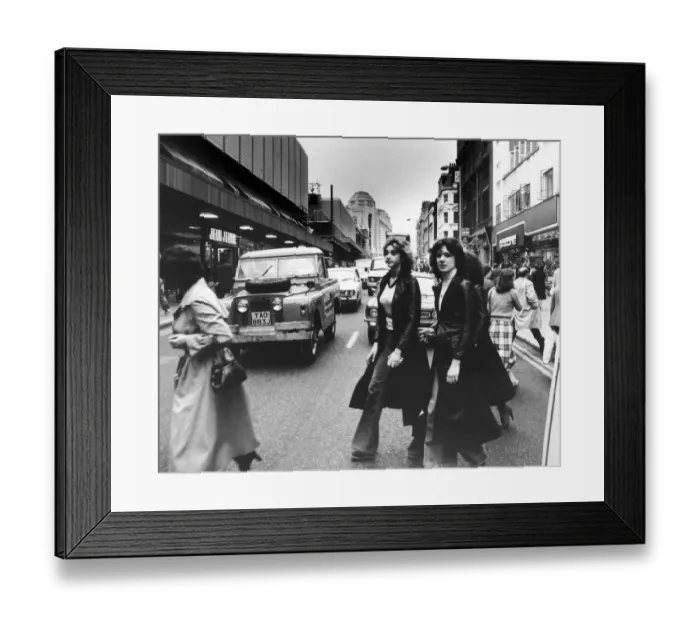 Framed Print : Shoppers out on a Saturday afternoon dodge the traffic in Manchester City Centre