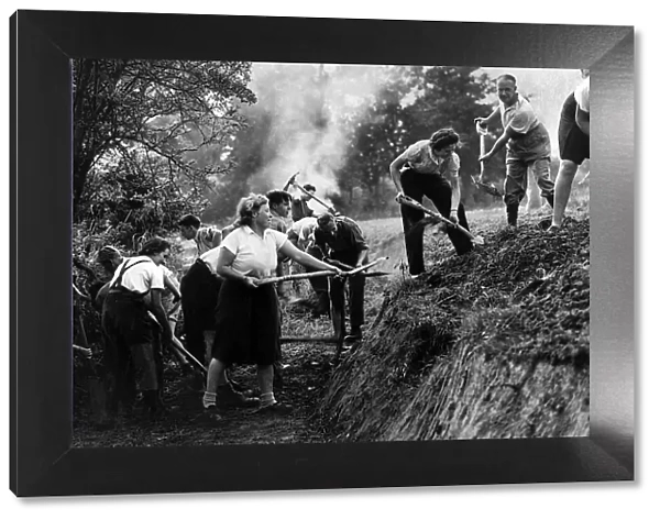 A 'Ditching'party of Women of the Volunteer Land Corps at work digging a deep
