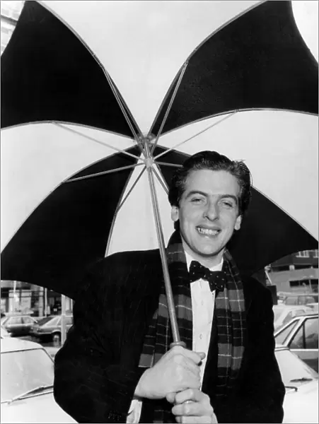 Actor Peter Capaldi holding an umbrella. March 1983