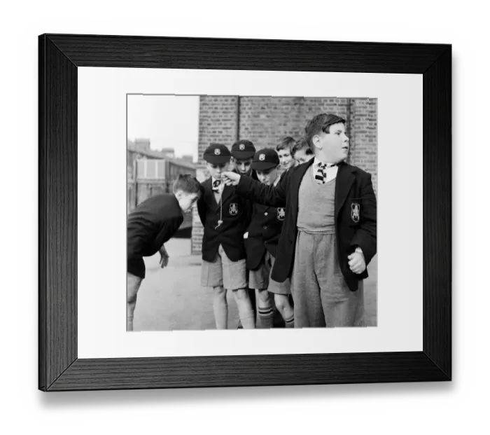 Framed Print : A group of friends taking part in a game of conkers at their school. September 1950