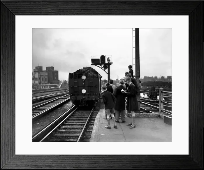 Framed Print : A group of boys take down the details of a Mechant Navy class steam train at Waterloo Framed Print : A group of boys take down the details of a Mechant Navy class steam train at Waterloo