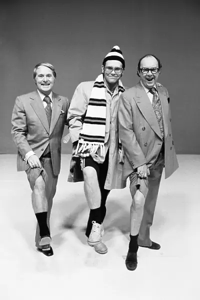 Elton John poses with comedians Ernie Wise (left) and Eric Morecambe as he appears