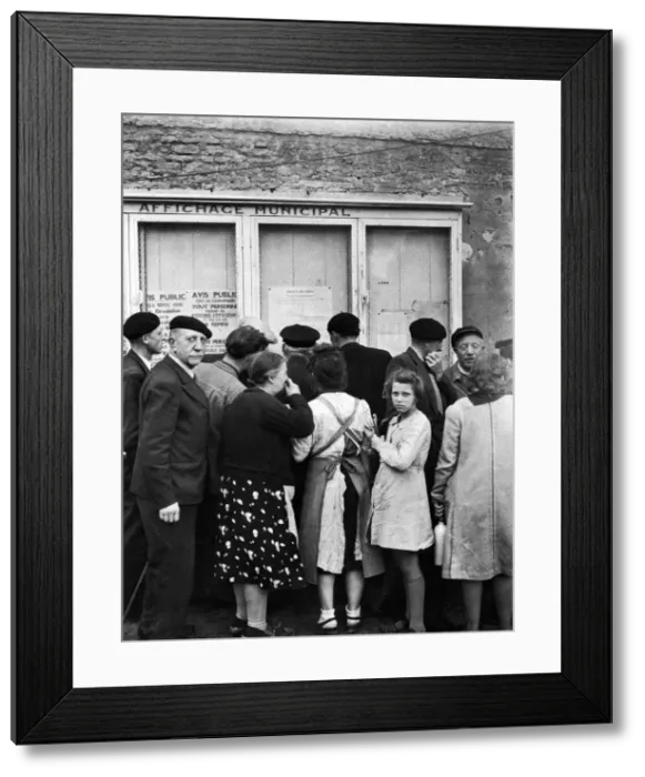 Framed Print : Citizens of Courseulles, Normandy read public notices put up by the Allied military Framed Print : Citizens of Courseulles, Normandy read public notices put up by the Allied military