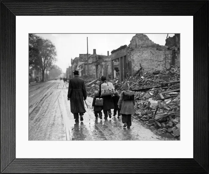 Framed Print : A man with his children walking the streets through a ruined French town during Framed Print : A man with his children walking the streets through a ruined French town during