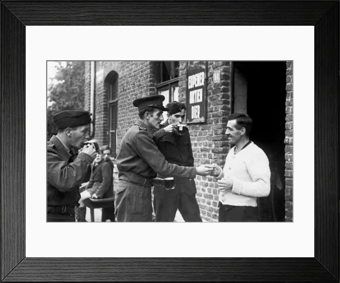 Framed Print : On the German border, war correspondant Rex North buys a drink for the road at the last Framed Print : On the German border, war correspondant Rex North buys a drink for the road at the last