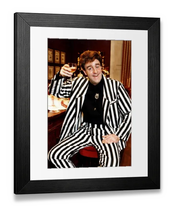 Framed Print : Iain McColl actor in black and white striped suit raising glass whisky toast STV Hogmanay