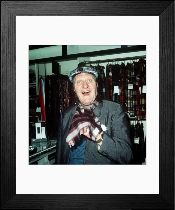 Framed Print : Comedian Tommy Cooper in a tartan shop 1974 Framed Print : Comedian Tommy Cooper in a tartan shop 1974