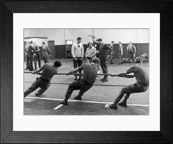 Framed Print : The Queen seen here watching a tug of war display during a visit to the Caterrick
