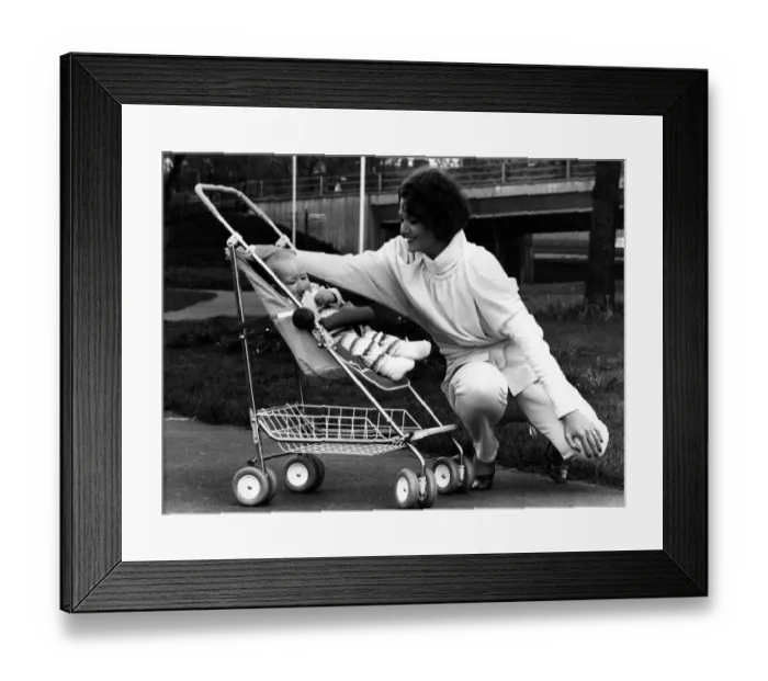 Framed Print : Rena pictured in a 1984-style jump suit and baby Thea relaxes in the new McLaren Dreamer