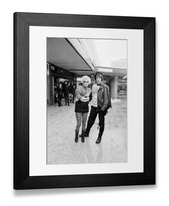 Framed Print : Punk Rock fashions in Birmingham. A young woman and man standing outside in a shopping Framed Print : Punk Rock fashions in Birmingham. A young woman and man standing outside in a shopping