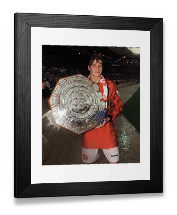 Framed Print : Football - Manchester Uniteds David Beckham celebrates holding the Charity Shield Framed Print : Football - Manchester Uniteds David Beckham celebrates holding the Charity Shield