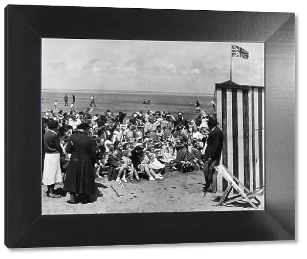 The Inevitable Punch and Judy show on the crowded Southport beach. 12th July 1950