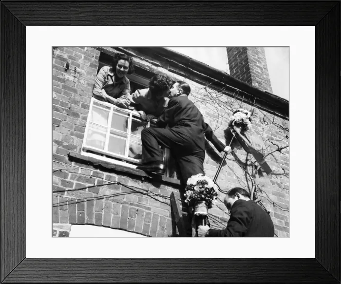 Framed Print : The tutti-men climb a ladder to get the traditional kiss the window during the Hock-tide Framed Print : The tutti-men climb a ladder to get the traditional kiss the window during the Hock-tide