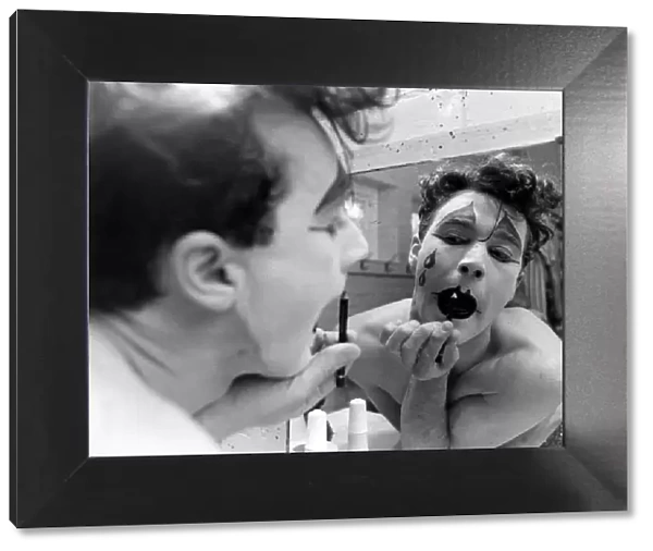 A circus clown painting painting on his face, 26th September 1983