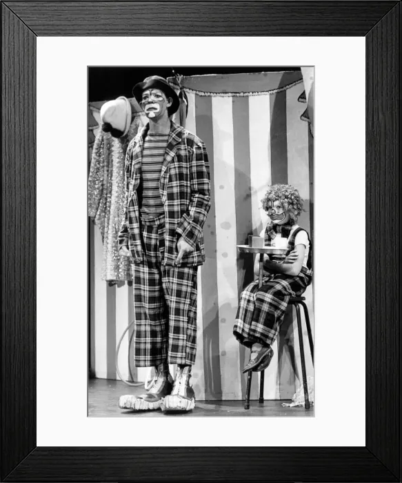 Framed Print : Two sad looking circus clowns, an adult and a young child. 26th September 1983 Framed Print : Two sad looking circus clowns, an adult and a young child. 26th September 1983