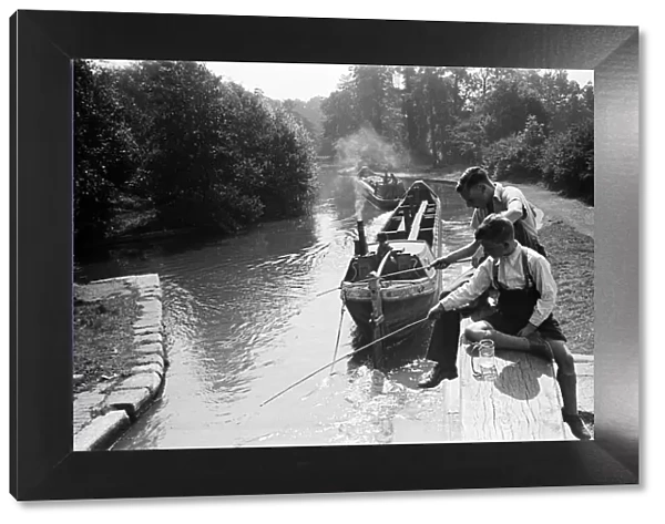 Young boys fishing on a canal near Watford, Hertfordshire. Circa 1945