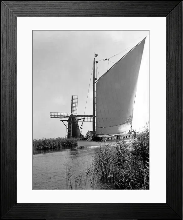 Framed Print : A traditional Norfolk Broad yachts sailing past one of the many windmill water pumps that Framed Print : A traditional Norfolk Broad yachts sailing past one of the many windmill water pumps that