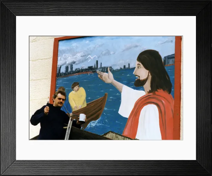 Framed Print : Art student Gary McNamara with the mural he has painted above the entrance to St Pius Framed Print : Art student Gary McNamara with the mural he has painted above the entrance to St Pius