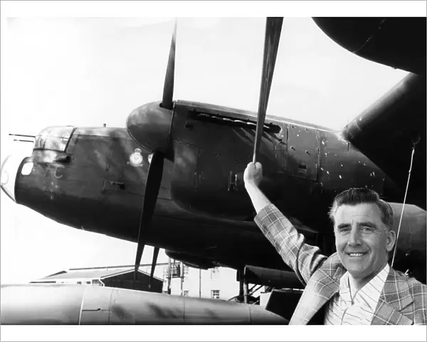 Former RAF flight engineer Alan Morgan in Lancasters, poses beside one of the famous Avro