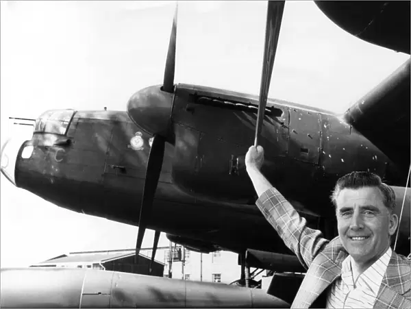 Former RAF flight engineer Alan Morgan in Lancasters, poses beside one of the famous Avro