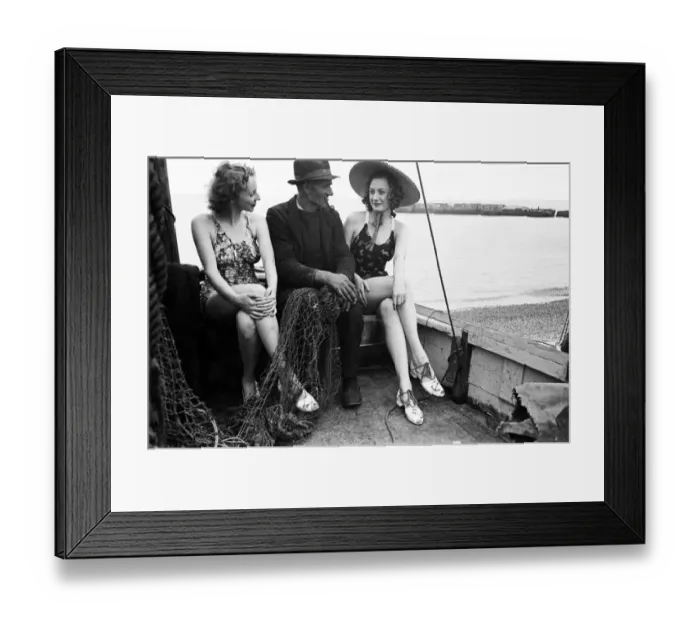 Framed Print : Women in their bathing costumes sitting in a fishing boat with a fisherman