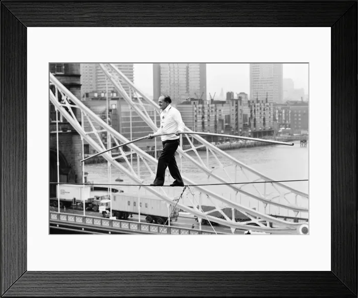Framed Print : Karl Wallenda, Tightrope Walker, crosses 100ft above the ground, near Tower Bridge