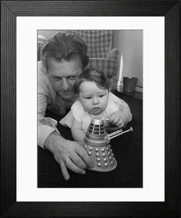 Framed Print : Raymond Cusick designer of the Daleks from Doctor Who 1965 playing with his Framed Print : Raymond Cusick designer of the Daleks from Doctor Who 1965 playing with his