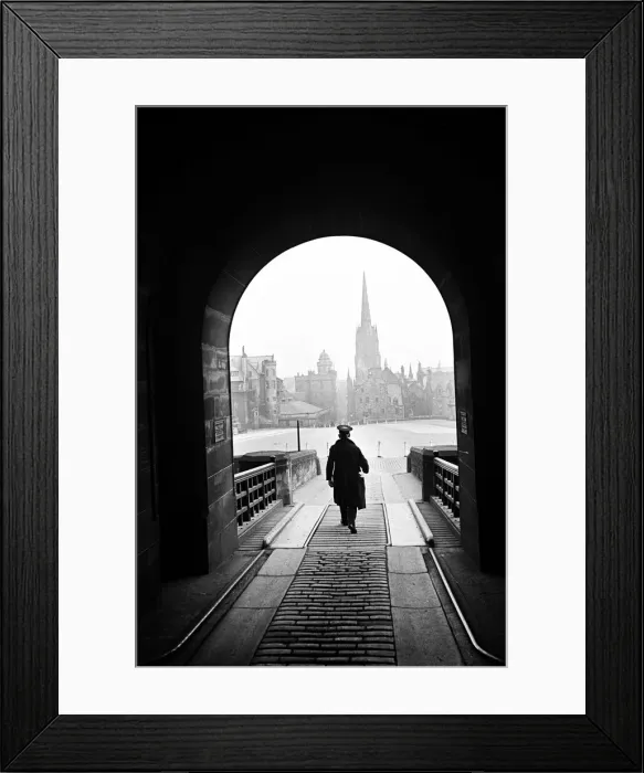 Framed Print : A man who helps operate the Time Gun walking through the entrance archway to Edinburgh Framed Print : A man who helps operate the Time Gun walking through the entrance archway to Edinburgh