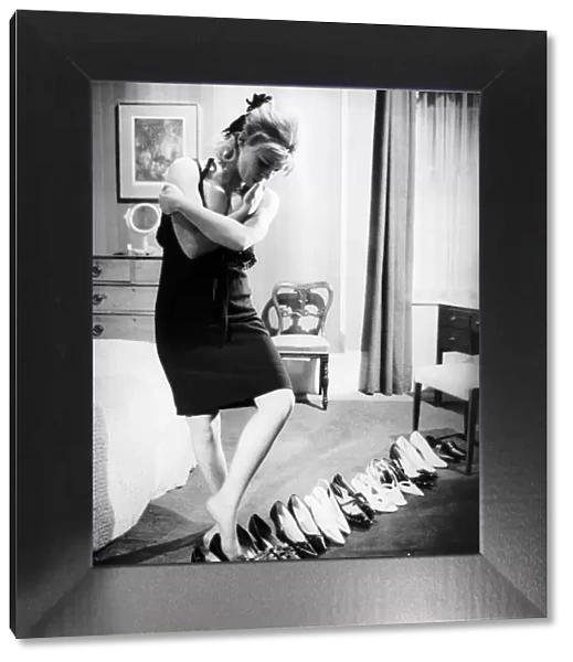 Julie Christie Actress in bedroom trying on shoes in the film Darling Dbase MSI